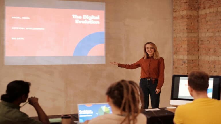 A woman giving a presentation on digital evolution to a group of people.