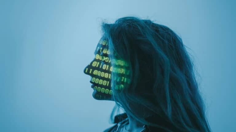 Silhouette of a person with binary code projected on their face, symbolizing AI and technology.