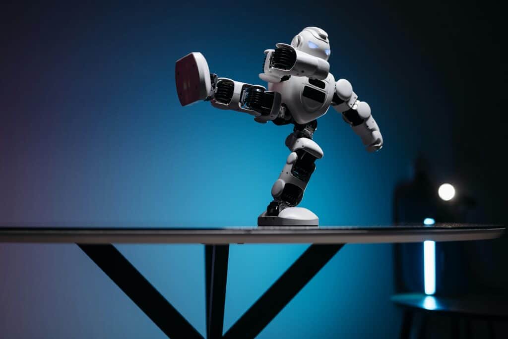 AI in craft workshop showing a sleek white robotic arm demonstrating precise movements against a blue gradient background