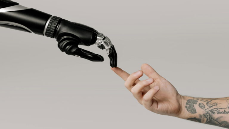 Robot hand touching human finger