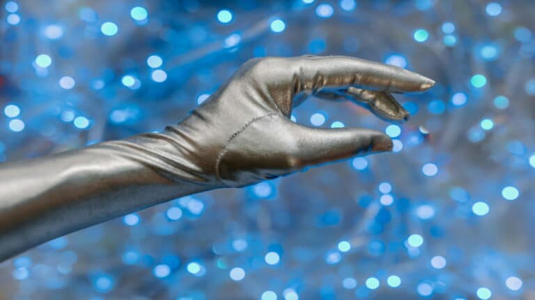 Silver gloved hand with blue bokeh background