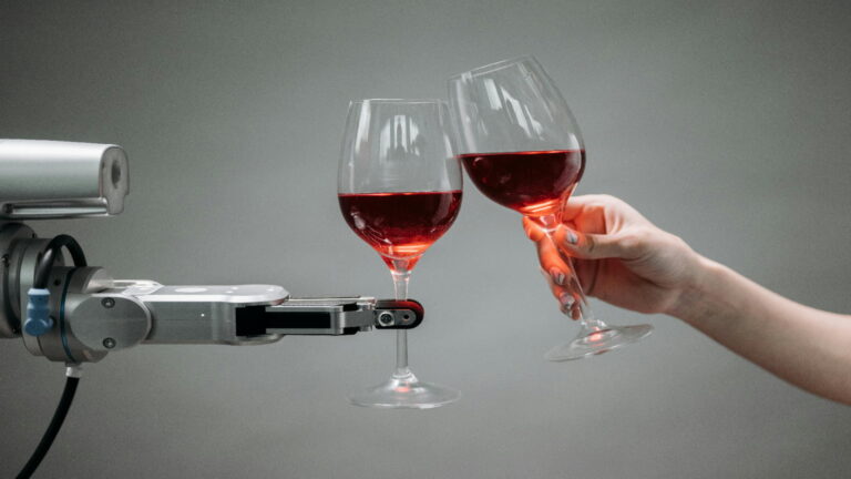 Robot arm clinking wine glasses with a human hand