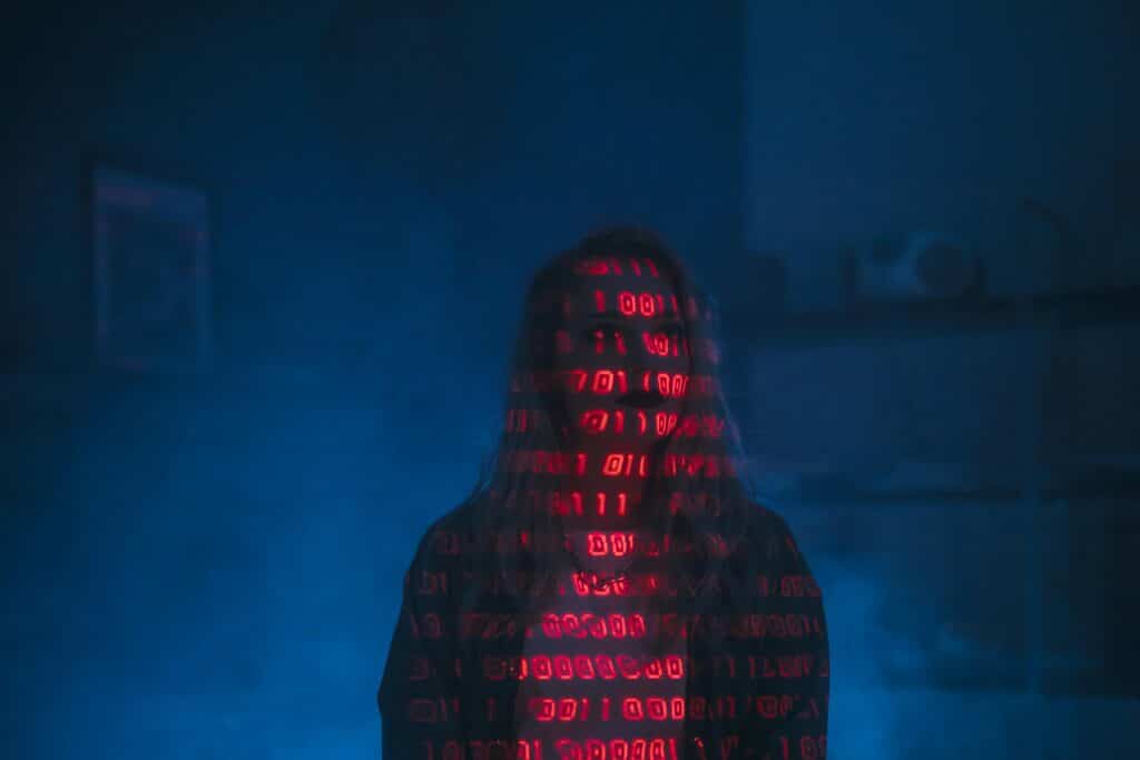 Silhouette of a person with binary code projected on their face, symbolizing AI for criminal defense law services