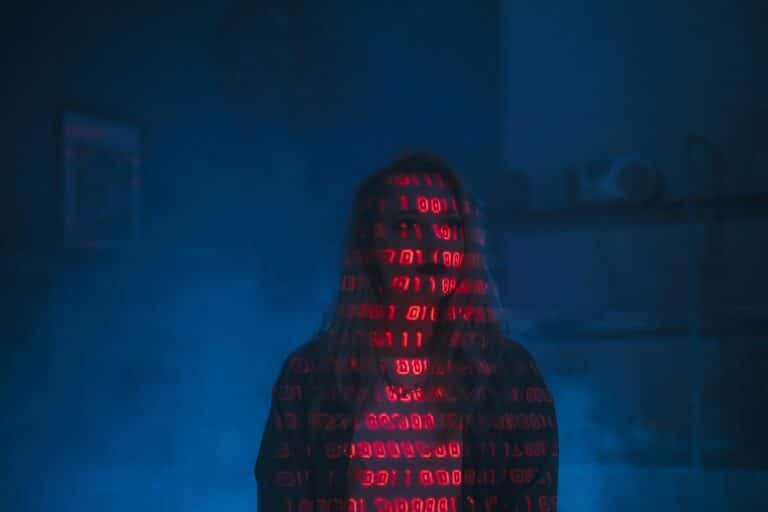 Silhouette of a person with binary code projected on their face, symbolizing AI for criminal defense law services