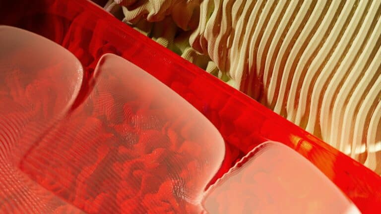 Abstract visual representation of AI for UI Design Services with vibrant red and beige patterns
