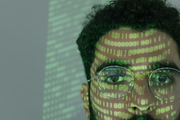 AI in Smart Home Solutions: Man with binary code reflecting, symbolizing AI integration.