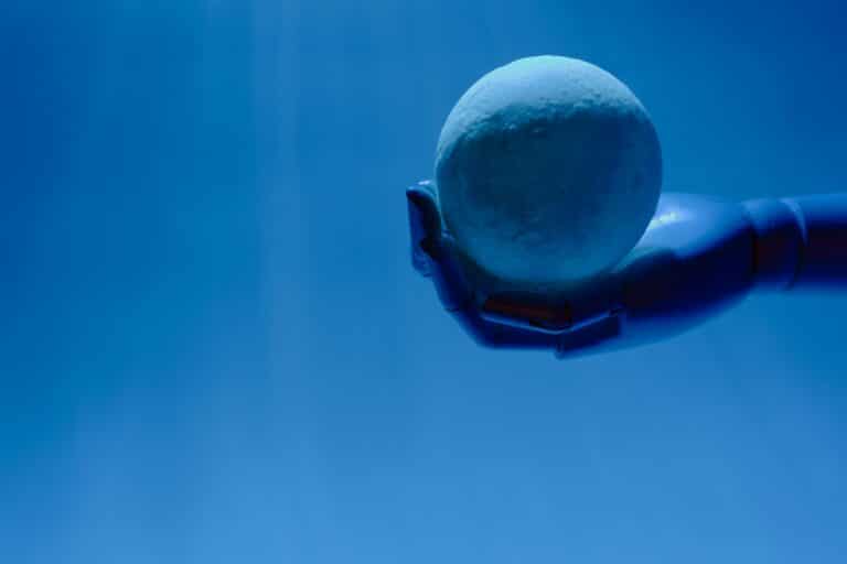 Robotic hand holding a sphere representing AI for inventory control solutions
