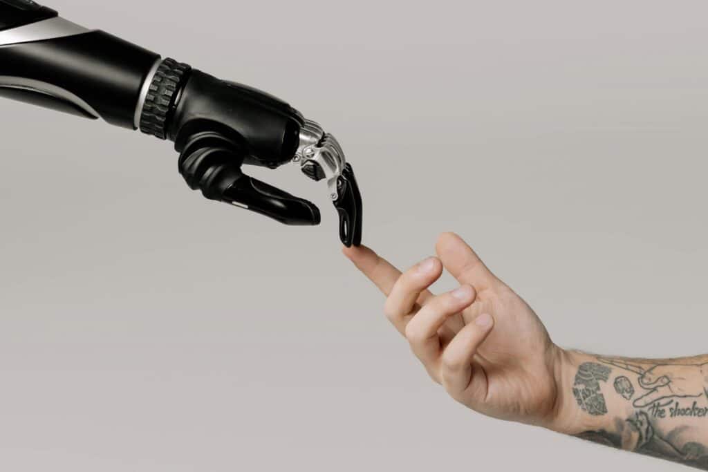Human hand reaching out to touch robotic hand symbolizing AI for Virtual Assistant Services creating seamless human-technology connection